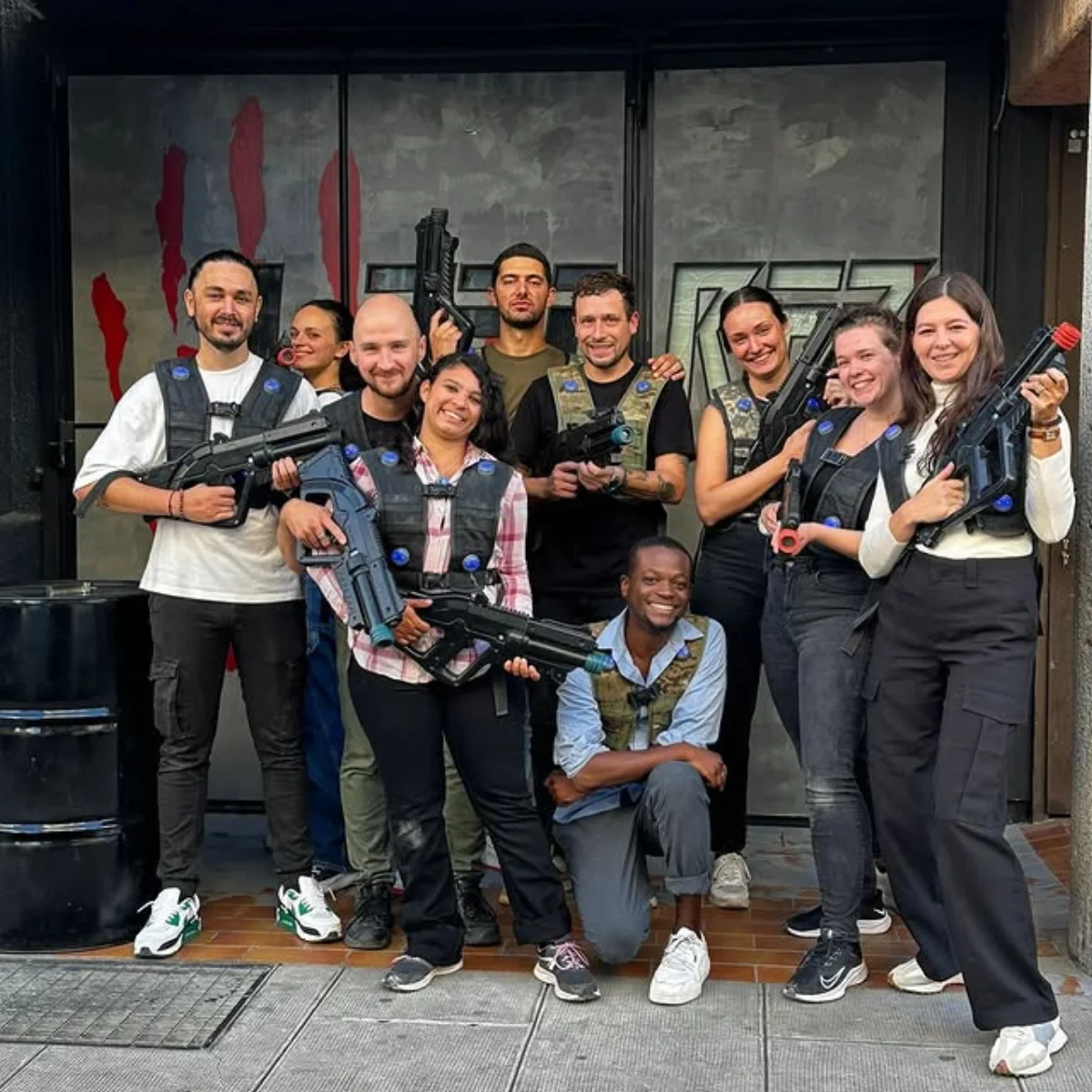 Mixed group of colleagues posing after a laser tag session